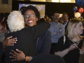 FILE - In this Nov. 6, 2018 file photo, Illinois candidate for the 14th congressional district Lauren Underwood visits with others at her election night party in St. Charles, Ill. on Tuesday, Nov. 6, 2018. Illinois Democrats did what was once unthinkable when they flipped two suburban Chicago congressional districts that had been held by Republicans pretty much since World War II. Underwood unseated four-term Republican Rep. Randy Hultgren.