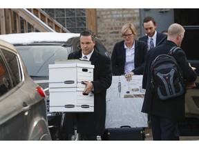 Boxes are carried away by investigators from Alderman Edward M. Burke's 14th Ward office in the 2600 block of West 51st Street in Chicago on Thursday, Nov. 29, 2018. Federal agents on Thursday executed search warrants at the City Hall office of Burke in an ongoing investigation, the Chicago Tribune reported.