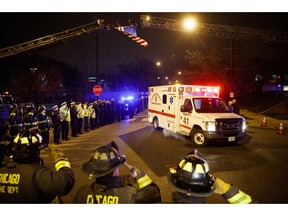 Police and firefighters salute as an ambulance arrives at the medical examiner's office carrying the body of Chicago Police Department Officer Samuel Jimenez, who was killed during a shooting at Mercy Hospital earlier in the day, Monday, Nov. 19, 2018, in Chicago.