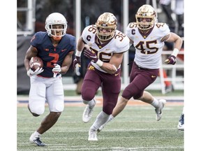 Illinois running back Reggie Corbin (2) runs the ball as Minnesota's Blake Cashman (36)and Carter Coughlin (45) pursue  in the first half of an NCAA  college football game, Saturday, Nov. 3, 2018, in Champaign, Ill.