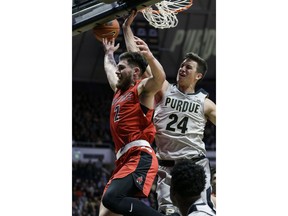 Ball State guard Tayler Persons (2) gets the ball knocked away by Purdue forward Grady Eifert (24) in the first half of an NCAA college basketball game in West Lafayette, Ind., Saturday, Nov. 10, 2018.