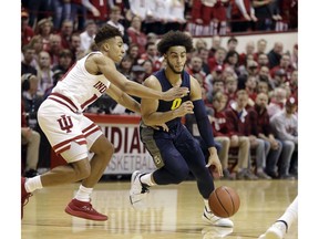Marquette's Markus Howard (0) drives against Indiana's Rob Phinisee during the first half of an NCAA college basketball game Wednesday, Nov. 14, 2018, in Bloomington, Ind.