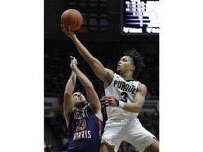 Purdue's Carsen Edwards, right, shoots over Robert Morris's Matty McConnell, left, during the second half of an NCAA college basketball game, Friday, Nov. 23, 2018, in West Lafayette, Ind. Purdue won 84-46.
