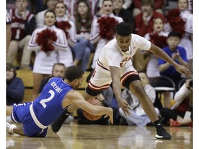 Indiana's Aljami Durham and Texas-Arlington's DJ Bryant go for a loose ball during the first half of an NCAA college basketball game, Tuesday, Nov. 20, 2018, in Bloomington, Ind.