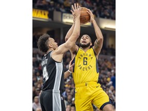 Indiana Pacers guard Cory Joseph (6) shoots while defended by San Antonio Spurs guard Derrick White (4) during the first half of an NBA basketball game in Indianapolis, Friday, Nov. 23, 2018.