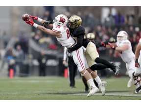 Purdue safety Navon Mosley (27) breaks up a pass to Wisconsin tight end Jake Ferguson (84) during the first half of an NCAA college football game in West Lafayette, Ind., Saturday, Nov. 17, 2018.