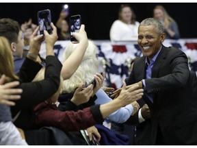 Former President Barack Obama, right, greets Democratic supporters at Genesis Convention Center, Sunday, Nov. 4, 2018, in Gary, Ind. Obama rallied Democrats on behalf of Sen. Joe Donnelly, D-Ind., who faces a stiff challenge from Republican businessman Mike Braun.