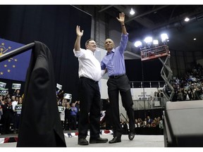 CORRECTS TO SAY THAT DONNELLY IS A CONGRESSIONAL CANDIDATE, NOT A GUBERNATORIAL CANDIDATE - Former President Barack Obama, right, and Democratic congressional candidate U.S. Sen. Joe Donnelly smile as they wave to the crowd during a campaign rally at Genesis Convention Center in Gary, Ind., Sunday, Nov. 4, 2018.