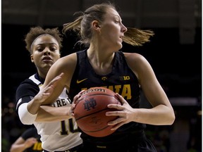 Iowa's Amanda Ollinger, right, is pressured from Notre Dame's Katlyn Gilbert (10) during the first half of an NCAA college basketball game Thursday, Nov. 29, 2018, in South Bend, Ind.