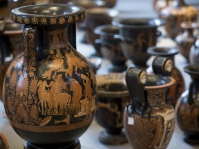 Antiquities recovered by Italian Carabinieri, military police, are displayed at Terme di Diocleziano museum during a press conference in Rome, Wednesday, Jan. 21, 2015. Italian authorities have unveiled what they said was a record haul of rare antiquities illegally looted from Italy and discovered during raids on Swiss warehouses belonging to an accused Sicilian art dealer. The carabinieri police's art squad estimated the value of the 5,361 vases, kraters, bronze statues and frescoes at some 50 million euros.