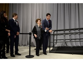 Prime Minister Justin Trudeau walks with Ana Maria Gordon, who was four-years-old when she travelled on the MS St. Louis, after their remarks at a reception following the formal apology for the fate of the ship carrying Jewish refugees in 1939, on Parliament Hill, Nov. 7, 2018.