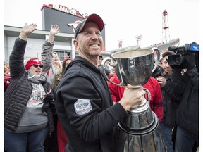 Calgary Stampeders head coach Dave Dickenson celebrates winning the Grey Cup with fans after returning to Calgary, Monday, Nov. 26, 2018.THE CANADIAN PRESS/Jeff McIntosh