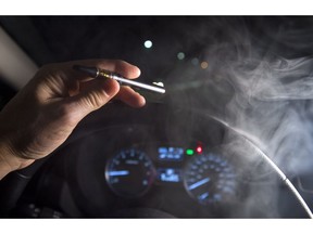 In this photo illustration, smoke from a cannabis oil vaporizer is seen as the driver is behind the wheel of a car in North Vancouver, B.C. Wednesday, Nov. 14, 2018. Canadian police have not seen a spike in cannabis-impaired driving one month since legalization, but there needs to be more awareness of laws around storing marijuana in vehicles and passengers smoking weed, law enforcement officials say.