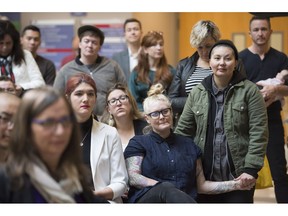 People listen to an announcement at the Vancouver General Hospital in Vancouver, B.C. Friday, Nov. 16, 2018. The announcement provided information on how transgender people in British Columbia will soon have access to publicly funded gender-affirming lower surgeries within the province.