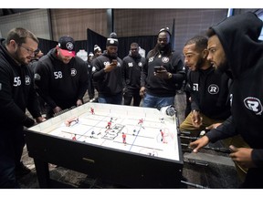 Members of the Ottawa Redblacks play table hockey during Grey Cup media day in Edmonton, Alta. Thursday, Nov. 22, 2018. The Ottawa Redblacks will play the Calgary Stampeders in the 106th Grey Cup on Sunday.