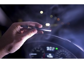 In this photo illustration, smoke from a cannabis oil vaporizer is seen as the driver is behind the wheel of a car in North Vancouver, B.C. Wednesday, Nov. 14, 2018. Canadian police have not seen a spike in cannabis-impaired driving one month since legalization, but there needs to be more awareness of laws around storing marijuana in vehicles and passengers smoking weed, law enforcement officials say.