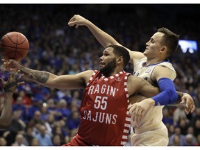 Louisiana Lafayette forward Justin Miller (55) is fouled by Kansas forward Mitch Lightfoot, right, during the first half of an NCAA college basketball game in Lawrence, Kan., Friday, Nov. 16, 2018.