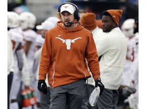 Texas head coach Tom Herman works the side lines during the first half of an NCAA college football game against Kansas in Lawrence, Kan., Friday, Nov. 23, 2018.