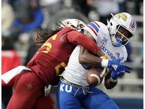 Iowa State defensive back Datrone Young, left, breaks up a pass intended for Kansas wide receiver Jeremiah Booker during the first half of an NCAA college football game in Lawrence, Kan., Saturday, Nov. 3, 2018.