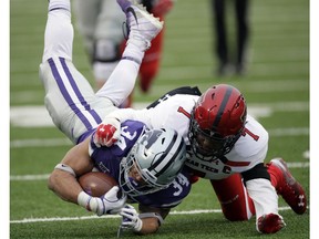 Kansas State running back Alex Barnes (34) is tackled by Texas Tech defensive back Jah'Shawn Johnson (7) during the first half of an NCAA college football game in Manhattan, Kan., Saturday, Nov. 17, 2018.