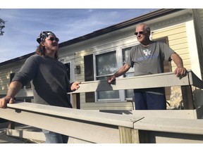 In this Oct. 30, 2018, photo, Don Albrecht, right, discusses the upcoming midterm election with his friend and handyman Joseph Robertson in Louisville, Ky. Albrecht voted for Trump in 2016 but has become frustrated with Trump's bombastic and divisive rhetoric. Robertson didn't vote in 2016, but he's also planning to go to the polls Tuesday to register his disappointment in Trump.