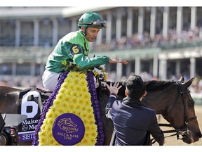 John Velazquez celebrates after riding Sistercharlie to victory in the Breeders' Cup horse race Filly and Mare Turf at Churchill Downs, Saturday, Nov. 3, 2018, in Louisville, Ky.