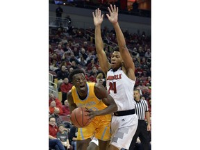 Southern forward Sidney Umude (20) yells as Louisville forward Dwayne Sutton (24) defends during the first half of an NCAA college basketball game, in Louisville, Ky., Tuesday, Nov. 13, 2018.