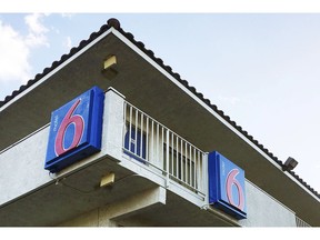 FILE - This Sept. 14, 2017, file photo shows a Motel 6 in Phoenix. The Motel 6 chain has agreed in a proposed settlement to pay up to $7.6 million to guests who say the company's employees shared their private information with immigration officials.