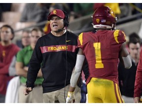Southern California coach Clay Helton, left, yells to his team as Southern California wide receiver Velus Jones Jr. walks off the field during the second half of an NCAA college football game against Notre Dame on Saturday, Nov. 24, 2018, in Los Angeles. Notre Dame won 24-17.