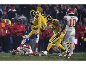 Los Angeles Rams outside linebacker Samson Ebukam (50) leaps over Kansas City Chiefs quarterback Patrick Mahomes (15) after Mahomes kept the ball during the second half of an NFL football game, Monday, Nov. 19, 2018, in Los Angeles.