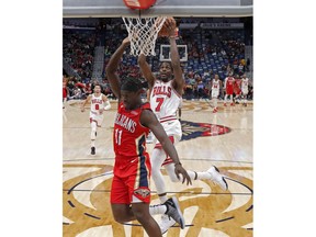 Chicago Bulls forward Justin Holiday (7) goes to the basket against his brother, New Orleans Pelicans guard Jrue Holiday (11), during the first half of an NBA basketball game in New Orleans, Wednesday, Nov. 7, 2018.