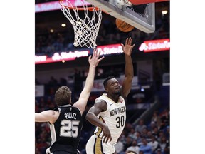 New Orleans Pelicans forward Julius Randle (30) shoots against San Antonio Spurs center Jakob Poeltl (25) in the first half of an NBA basketball game in New Orleans, Monday, Nov. 19, 2018.