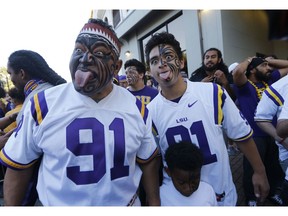 Vili Fehoko, left, father of LSU defensive end Breiden Fehoko, makes a face after family members greeted his son with a haka, a Maori ceremonial dance, as the team arrived at Tiger Stadium before an NCAA college football game against Alabama in Baton Rouge, La., Saturday, Nov. 3, 2018.