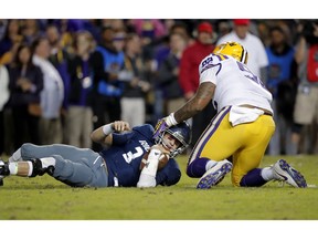 Rice quarterback Shawn Stankavage (3) looks up after being sacked by LSU defensive end Neil Farrell Jr. (92) in the first half of an NCAA college football game in Baton Rouge, La., Saturday, Nov. 17, 2018.