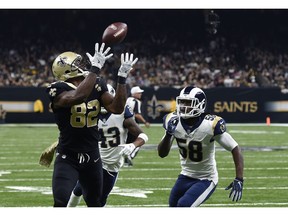 New Orleans Saints tight end Benjamin Watson (82) pulls in a touchdown pass in front of Los Angeles Rams strong safety John Johnson (43) and inside linebacker Cory Littleton (58) in the first half of an NFL football game in New Orleans, Sunday, Nov. 4, 2018.