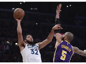 Minnesota Timberwolves center Karl-Anthony Towns, left, shoots as Los Angeles Lakers center Tyson Chandler defends during the first half of an NBA basketball game Wednesday, Nov. 7, 2018, in Los Angeles.