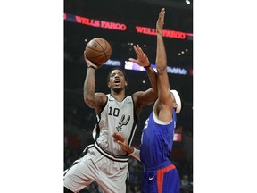 San Antonio Spurs guard DeMar DeRozan, left, drives to the basket past Los Angeles Clippers forward Tobias Harris during the first half of an NBA basketball game in Los Angeles, Thursday, Nov. 15, 2018.