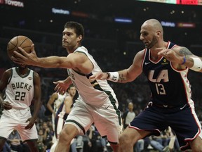 Milwaukee Bucks' Brook Lopez, left, grabs a rebound against Los Angeles Clippers' Marcin Gortat during the first half of an NBA basketball game Saturday, Nov. 10, 2018, in Los Angeles.