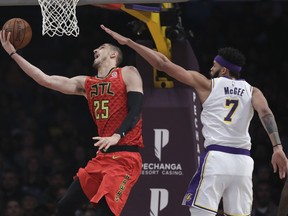 Atlanta Hawks' Alex Len (25) drives past Los Angeles Lakers' JaVale McGee during the first half of an NBA basketball game Sunday, Nov. 11, 2018, in Los Angeles.