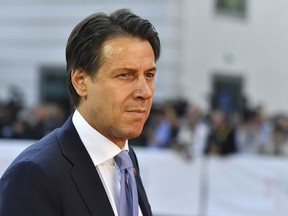 FILE - In this Thursday, Sept. 20, 2018 file photo, Italian Prime Minister Giuseppe Conte arrives at the informal EU summit in Salzburg, Austria. A gathering of leaders of Libya's quarrelling factions and of countries keen on stabilizing the North African nation opens in Monday Nov. 12, 2018, where Italian Premier Giuseppe Conte will be greeting arrivals Monday evening in Sicily, aimed at finding a political settlement that would bolster the fight against Islamic militants and stop illegal migrants crossing the Mediterranean to Europe's southern shores.