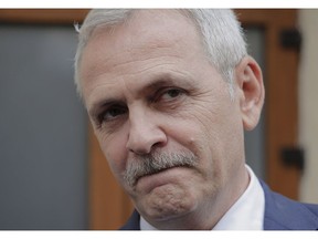 FILE - In this April 27, 2018 file photo, the leader of Romania's ruling Social Democratic party, Liviu Dragnea, grimaces as he walks out of the anti-corruption prosecutors' office, in Bucharest, Romania. Romania's ruling Social Democratic Party fired six ministers on Monday, Nov. 19, 2018, as Dragnea sought to tighten his grip on the government.