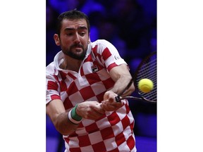Croatia's Marin Cilic returns the ball to France's Lucas Pouille during the Davis Cup final between France and Croatia Sunday, Nov. 25, 2018 in Lille, northern France.