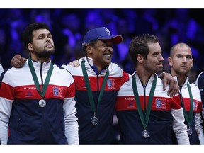 French team captain Yannick Noah, center, grimaces with players France's Jo-Wilfried Tsonga, left, and, France's Richard Gasquet after the Davis Cup final between France and Croatia Sunday, Nov. 25, 2018 in Lille, northern France. Marin Cilic sealed Croatia's victory over defending champion France in the Davis Cup final with a 7-6 (3), 6-3, 6-3 .