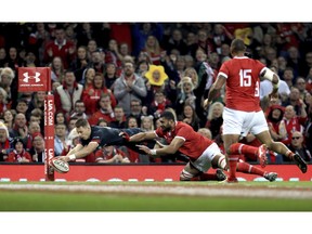 Wales' Liam Williams, left, scores his team's third try during their Autumn International rugby union match at the Principality Stadium, Cardiff, Wales, Saturday, Nov. 17, 2018.