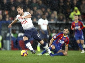 Tottenham Hotspur's Harry Kane, left, and Crystal Palace's Luka Milivojevic battle for the ball during their English Premier League soccer match at Selhurst Park, London, Saturday, Nov. 10, 2018.