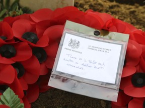 The wreath of Britain's Prime Minister Theresa May at the grave of John Parr, the first British soldier to be killed in WWI in 1914, at the St Symphorien Military Cemetery in Mons, Friday Nov. 9, 2018.