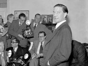 FILE - In this file photo dated Nov. 8, 1955, Former British diplomat and journalist Harold "Kim" Philby faces the media at his parents' London house.  The Mayor of Moscow Sergei Sobyanin on Tuesday Nov. 6, 2018, decreed that a square near the headquarters of Russia's SVR foreign intelligence service be named after Kim Philby, the Briton who was the most successful Soviet double agent of the Cold war period. (AP Photo)