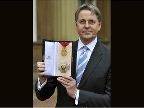 FILE - In this May 4, 2012 file photo, Jeremy Heywood, permanent secretary at No 10 and Cabinet Secretary, shows his Knight Commander of the Order of the Bath. The British government says Jeremy Heywood, who ran the country's civil service until illness forced him to step down, has died of cancer, early Sunday Nov. 4, 2018. He was 56.