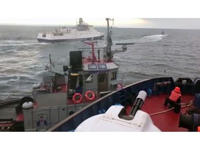 In this image taken from video released by the Russia's Federal Security Service taken from a Russian Coast Guard vessel purporting to show an incident between the Russian coast guard and a Ukrainian tugboat, in the Kerch Strait on Sunday Nov. 25, 2018. Russia said three Ukrainian vessels made an unauthorised passage through Russian territorial waters, while Ukraine alleged that one of its boats was rammed by a Russian coast guard vessel.