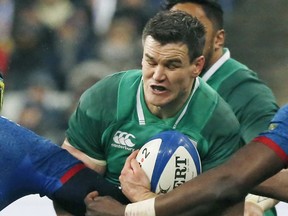 FILE - In this file photo dated Saturday, Feb. 3, 2018, Ireland's Jonathan Sexton, is caught by France players during their Six Nations rugby union match at the Stade de France stadium in Saint-Denis, outside Paris, France.  Sexton on Monday Nov. 12, 2018, said he supports Conor Murray's "smart" call not to make Ireland's showdown with the All Blacks upcoming weekend his first match in five months after suffering a neck injury.